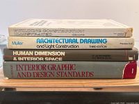 Stack of four books showing titles and wear on covers and spines.