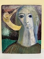 Close front view of the painted board showing the woman's face and moon figure playing instrument with visible brushstrokes.