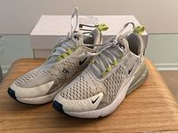 Pair of Nike Air Max 270 women's running shoes size 7.5 with original box in background, showing overall condition and color.
