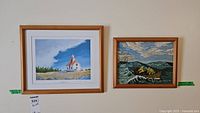 Both framed art pieces side-by-side on a wall showing the full works, framing, and condition.