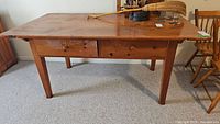 Front view of pine table showing two drawers and overall condition