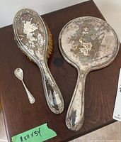 All three sterling silver items on wooden surface showing overall condition and sizes.