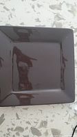 Top view of one brown square dinner plate showing glossy finish and smooth edges.