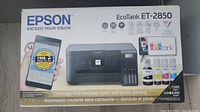 Box showing Epson EcoTank ET-2850 branding and highlighting cartridge-free refill system and ink bottles included.