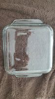 Top view of clear rectangular Pyrex glass baking dish showing the full shape and handles.