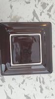 Square ceramic dish with glossy dark brown finish and lighter brown square center, shown from front