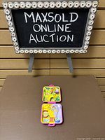 Photo of closed and open 1989 Polly Pocket compact showing front and interior playset details.