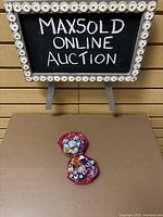 Polly Pocket compact open on table under display sign