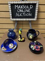 Full lot overview on brown table beneath MaxSold sign