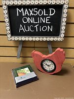 Overview of lot: wooden chicken shaped clock and boxed set of coasters.