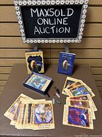 Angel Therapy Oracle Cards and Guidebook shown with seven crystals and cards spread out in front.