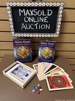 Photo showing the full set including the oracle deck box, guidebook, spread of cards, and crystals.