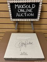 Photo of the box for the Rosenthal Weihnachtslieder auf Porzellan collectible plate with Jingle Bells theme, showing branding and signature on the box top.