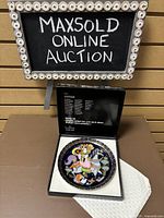 Photo of the boxed Rosenthal collector's plate with Aladin motif showing front detail of the plate inside the open box