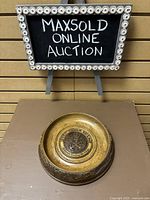 Upper Canada Village carved wood bowl shown from a distance with small blackboard sign for reference.