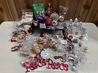 Full collection of various Christmas ornaments displayed on a white table.