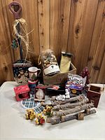 Photo showing full assortment of Christmas and holiday decor on a table against a wooden wall background.