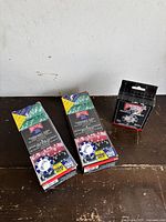 Three boxes of Bicycle brand poker chips, two boxes laying down showing front and back, one box standing upright to show front packaging