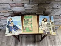 Three Eaton's 1976 catalogs placed side by side showing front covers and some wear.