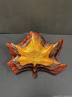 Photo showing all three leaf shaped nesting dishes stacked inside one another, highlighting their colors and sizes.