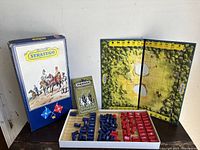 Full contents of vintage Stratego game including box, board, pieces, and booklet.