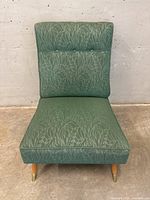 Front view showing overall shape, upholstery pattern, seat and back cushions, and legs.