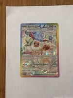 Front of Eevee ex Rainbow Rare card on white paper