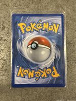 Back of the Special Delivery Charizard card showing the classic Pokémon card backside design with Pokéball.