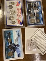 Overhead shot of four carded coin sets and slabbed half-dollar on table