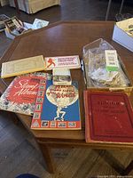 Overview photo of stamp albums and bag of loose stamps on wooden table