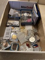 Overview of all tokens and coins in cardboard box