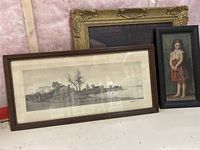 Vintage farm landscape print in wood frame alongside smaller framed oil painting of young girl