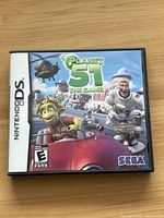 Front cover of the Planet 51 game case for Nintendo DS showing main characters and SEGA logo.