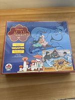 Front of sealed Disney Aladdin Magic Carpet Gigantik board game box showing artwork of Genie and Aladdin with Jasmine, and game logo