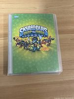 Front cover of green Skylanders Swap Force card binder with logo and characters