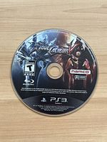 Top surface of Soul Calibur V PS3 game disc showing title art and branding.