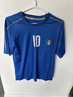 Front view of blue Italy national soccer jersey with number 10 and team crest