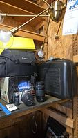 Soft Canon camera bag, Canon DSLR with kit lens, telephoto lens and hard case on wooden shelf