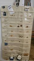 Hanging organizer displaying over 30 pairs of mixed pierced earrings