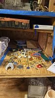 Pinned collection of Freemason and Shriners memorabilia items on a wooden surface, including a variety of metal and embroidered patches and pins.