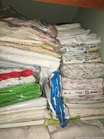 Shelf full of sheet sets in original and loose packaging with visible brand names and size labels
