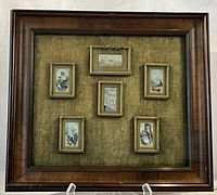Full view of wooden shadow box with six miniature prints on green velvet