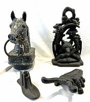 All four items grouped together: horse head, fox door stop, boot remover and shoe mold