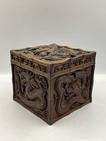 Front and side view showing the detailed dragon carving on the box sides and top lid.