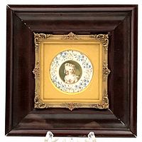 Frontal view of the shadow boxed framed miniature portrait with ornate inner gilt frame.