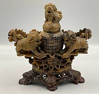 Front view of the hand carved soapstone Foo dog incense burner showing detailed carving and removable lid.