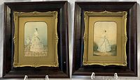 Pair of framed Baxter prints displayed side-by-side showing full shadow box style wooden frames with ornate gold inner borders.