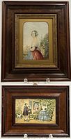 Two Baxter prints framed in wooden frames with gilded inner borders, displayed upright on stand. One larger portrait of a woman, one smaller scene with people outside a house.