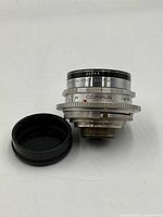 Side view showing Voigtlander stamp MADE IN WEST GERMANY and COMPUR shutter ring alongside lens cap