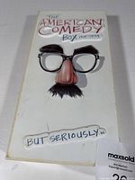 Front cover of The American Comedy Box 1915-1994 showing a Groucho Marx style comedic disguise on a white background with the title.
